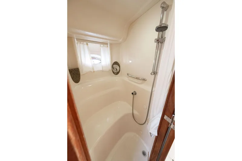 Slide: The Image of Shower area in 2005 Sea Ray 420 Sundancer yacht, featuring sleek design and modern fixtures. - 44