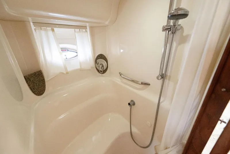 Slide: The Image of Luxurious bathroom in 2005 Sea Ray 420 Sundancer yacht with shower and porthole window. - 45