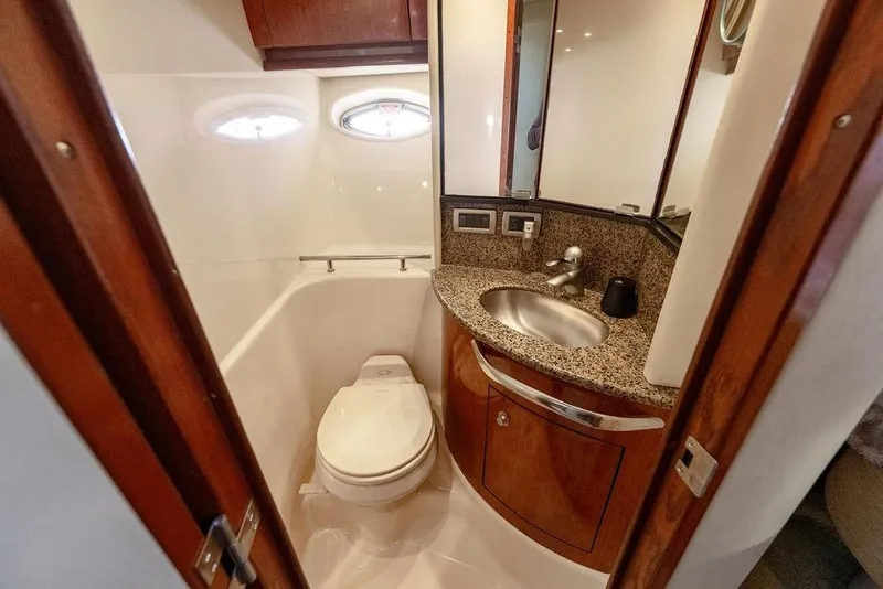 Slide: The Image of Luxurious bathroom in 2005 Sea Ray 420 Sundancer yacht with granite countertop and porthole windows. - 47