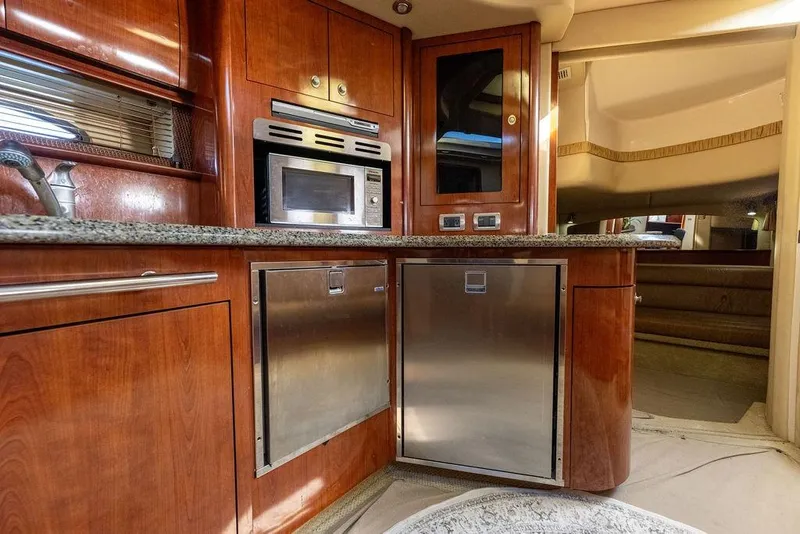 Slide: The Image of Luxurious 2005 Sea Ray 420 Sundancer yacht interior with modern kitchen amenities. - 53