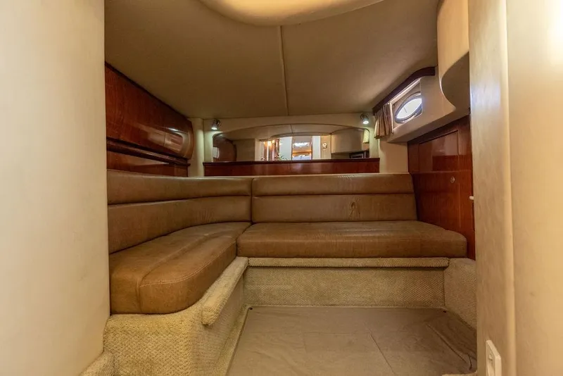Slide: The Image of Interior cabin of 2005 Sea Ray 420 Sundancer with beige seating and wood accents. - 59
