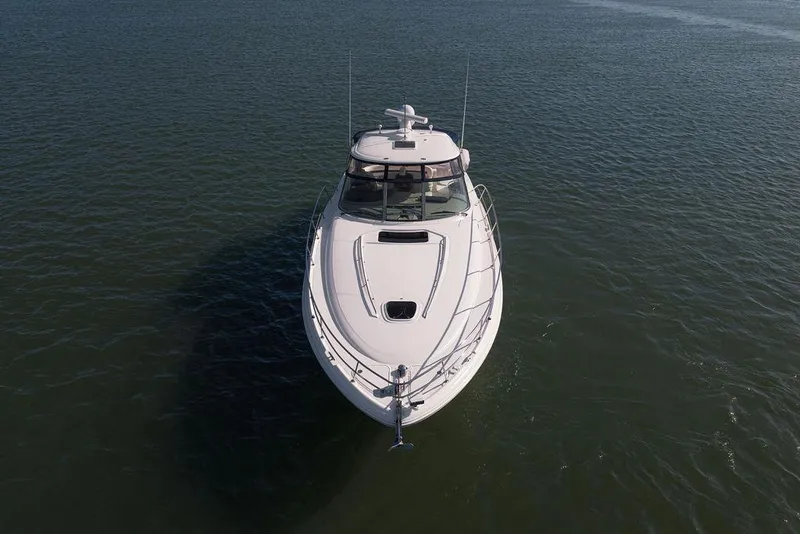 Slide: The Image of 2005 Sea Ray 420 Sundancer yacht cruising on open water. - 6