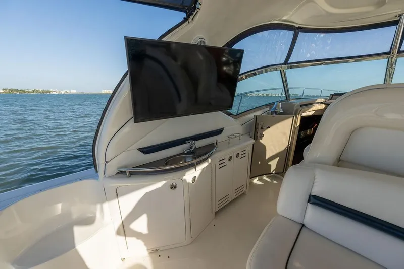 Slide: The Image of Interior of 2005 Sea Ray 420 Sundancer yacht with TV and sink, overlooking water. - 60