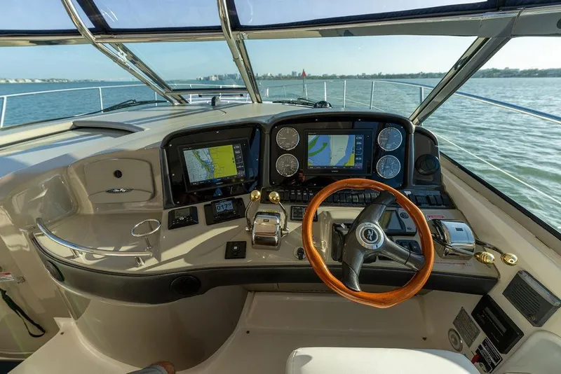 Slide: The Image of Helm of 2005 Sea Ray 420 Sundancer yacht with navigation screens and wooden steering wheel. - 66