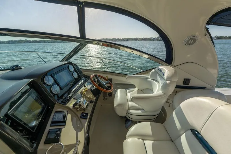 Slide: The Image of Luxurious 2005 Sea Ray 420 Sundancer yacht cockpit with leather seating and modern controls. - 67