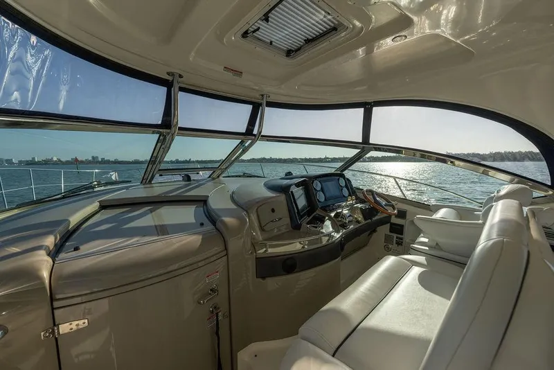 Slide: The Image of Interior view of 2005 Sea Ray 420 Sundancer yacht cockpit with panoramic water view. - 68