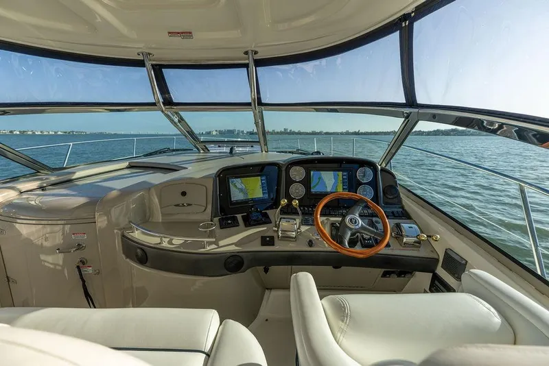 Slide: The Image of Cockpit view of 2005 Sea Ray 420 Sundancer yacht with navigation screens and steering wheel. - 69