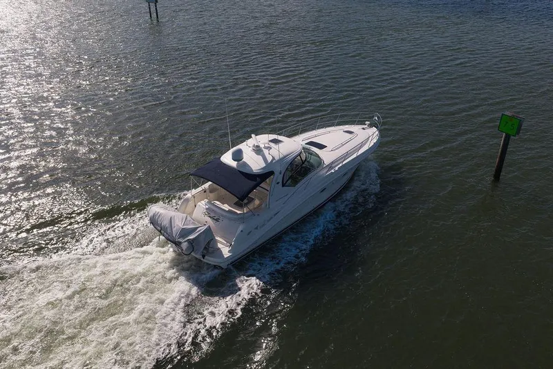Slide: The Image of 2005 Sea Ray 420 Sundancer cruising on open water, viewed from above. - 7