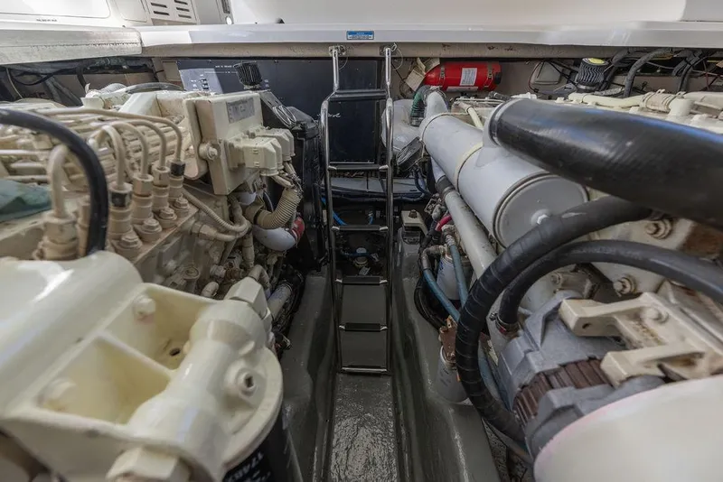 Slide: The Image of Engine room of a 2005 Sea Ray 420 Sundancer, showcasing dual engines and equipment. - 74