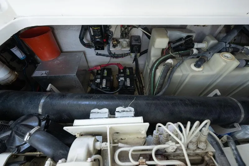 Slide: The Image of Engine compartment of a 2005 Sea Ray 420 Sundancer with visible batteries and wiring. - 77