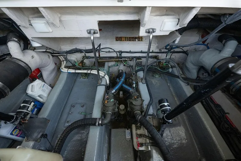 Slide: The Image of Engine room of a 2005 Sea Ray 420 Sundancer, showcasing mechanical components and wiring. - 78
