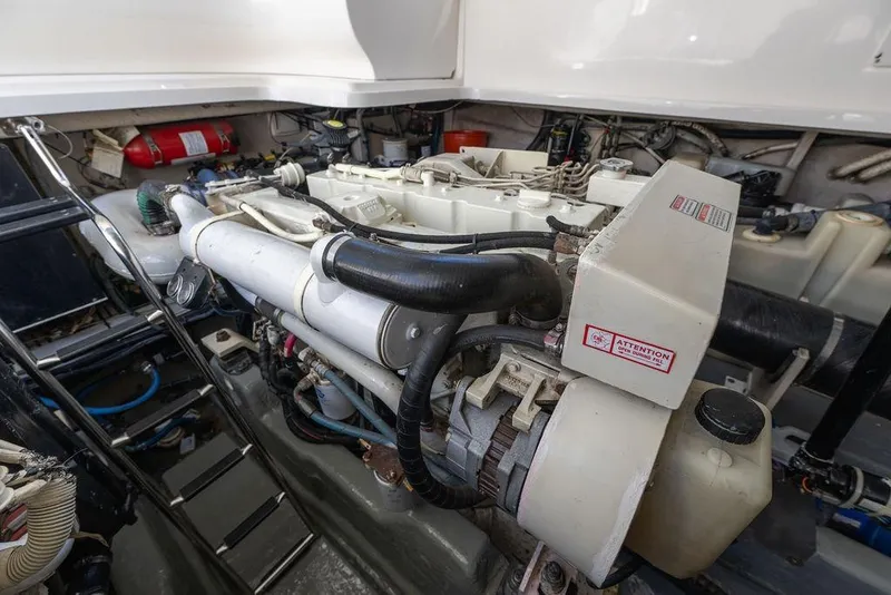 Slide: The Image of Engine room of 2005 Sea Ray 420 Sundancer, showcasing mechanical components and equipment. - 79