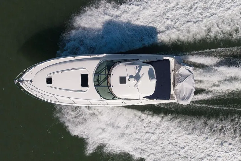 Slide: The Image of Aerial view of 2005 Sea Ray 420 Sundancer cruising on water. - 8
