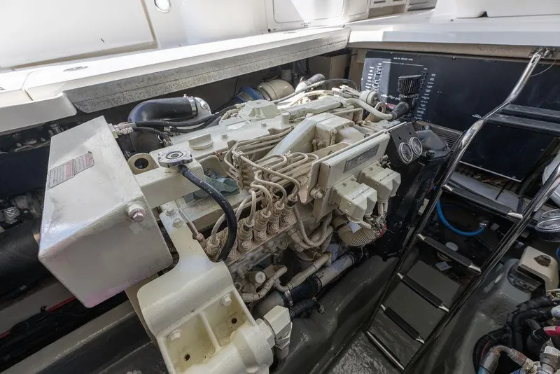 Slide: The Image of Engine compartment of a 2005 Sea Ray 420 Sundancer yacht, showcasing detailed machinery. - 80