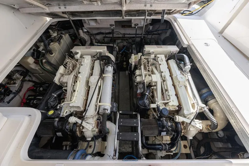 Slide: The Image of Engine room of a 2005 Sea Ray 420 Sundancer, showcasing dual marine engines. - 81