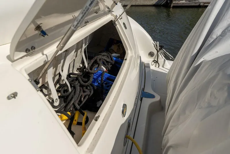 Slide: The Image of Storage compartment of a 2005 Sea Ray 420 Sundancer boat with ropes and tools. - 82