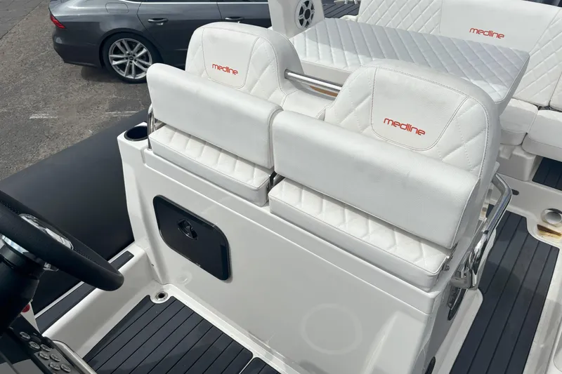 Slide: The Image of 2026 Zodiac Medline 7.5 GT boat interior with white seating and steering wheel. - 12