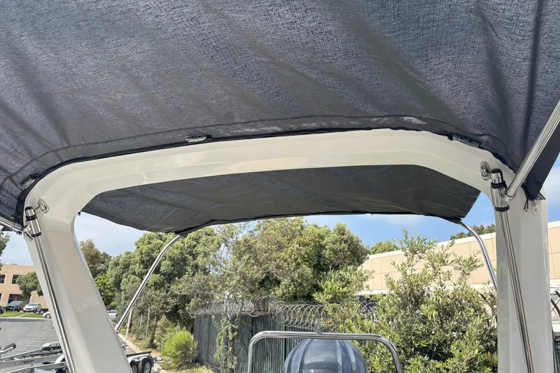 Slide: The Image of 2026 Zodiac Medline 7.5 GT boat canopy with trees and buildings in the background. - 17