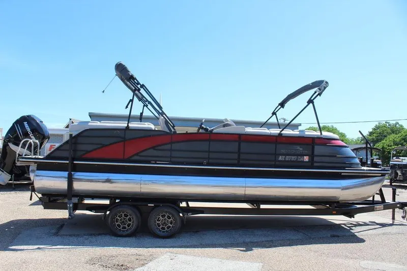 Slide: The Image of 2019 Bennington 25 QSR pontoon boat on trailer, featuring sleek design and dual bimini tops. - 3
