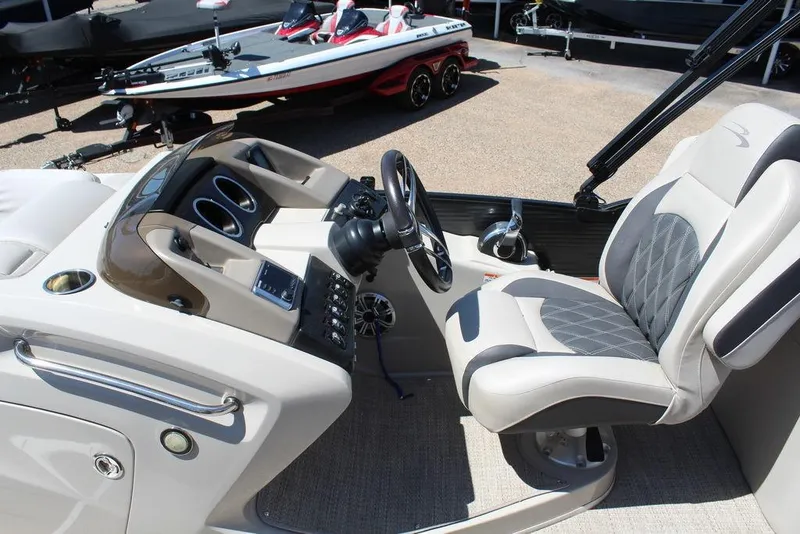 Slide: The Image of 2019 Bennington 25 QSR boat interior with modern helm and comfortable seating. - 4