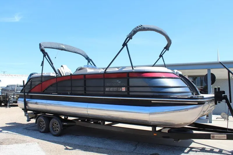 Slide: The Image of 2019 Bennington 25 QSR pontoon boat on trailer, featuring sleek design and dual bimini tops. - 9
