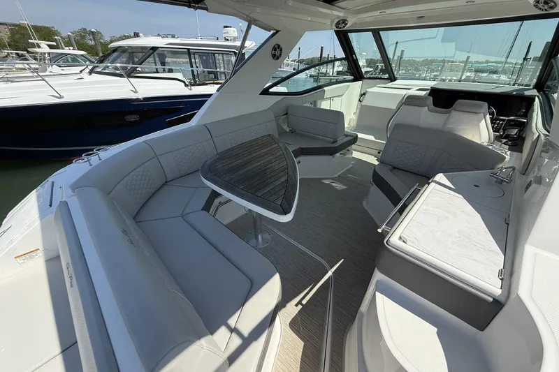 Slide: The Image of 2023 Sea Ray Sundancer 320 interior with elegant seating and modern design. - 11