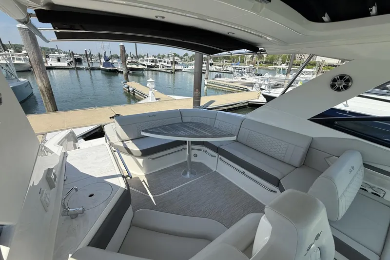 Slide: The Image of Luxurious 2023 Sea Ray Sundancer 320 yacht interior with elegant seating and marina view. - 13