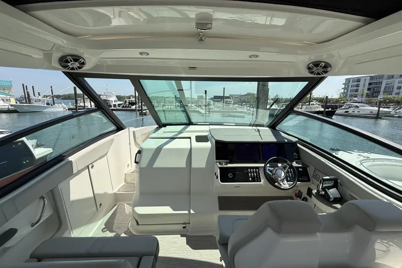 Slide: The Image of Interior view of 2023 Sea Ray Sundancer 320 yacht cockpit at marina. - 19