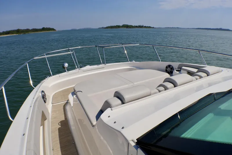Slide: The Image of 2023 Sea Ray Sundancer 320 yacht with spacious deck, cruising on calm waters. - 24
