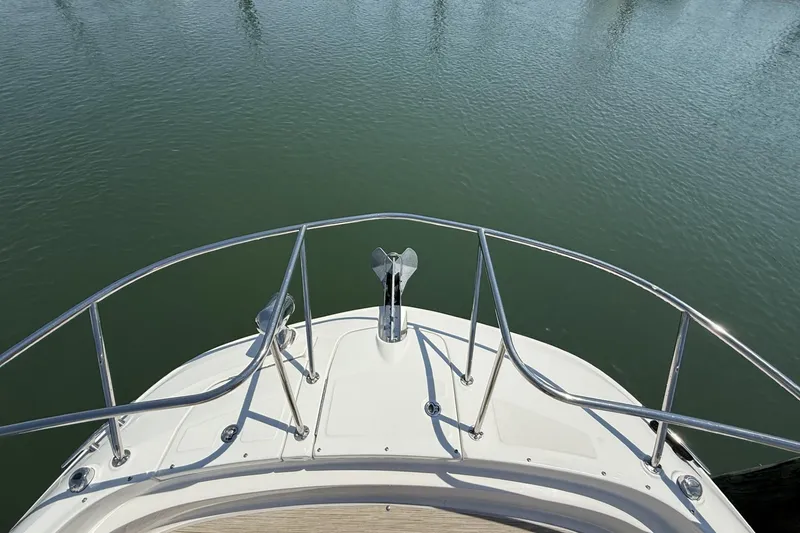 Slide: The Image of Bow view of 2023 Sea Ray Sundancer 320 yacht on calm water. - 25