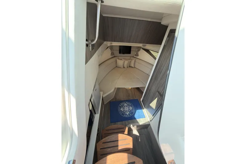 Slide: The Image of Interior cabin of 2023 Sea Ray Sundancer 320, featuring cozy seating and modern design. - 26