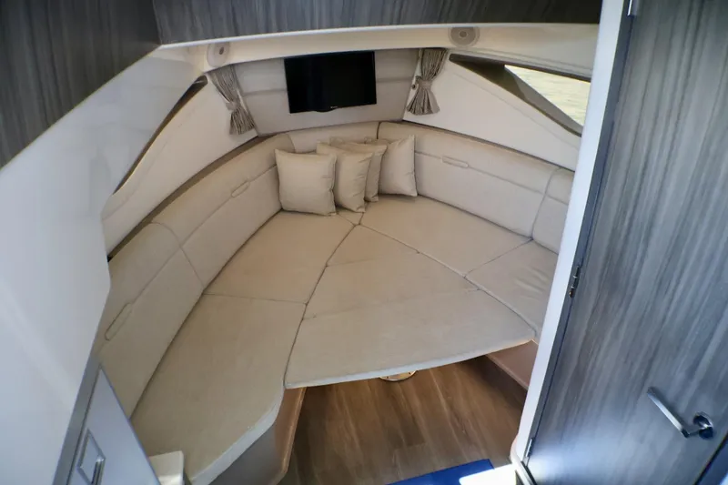 Slide: The Image of 2023 Sea Ray Sundancer 320 cabin interior with beige seating and modern design. - 27