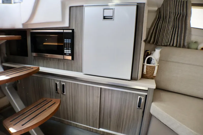 Slide: The Image of 2023 Sea Ray Sundancer 320 interior with microwave and modern cabinetry. - 28