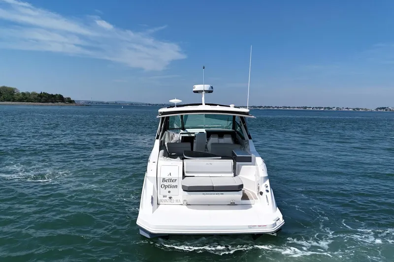 Slide: The Image of 2023 Sea Ray Sundancer 320 cruising on open water under clear blue skies. - 5