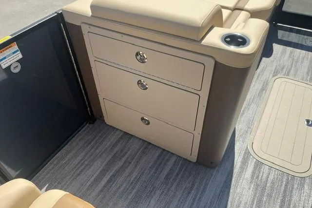 Slide: The Image of Interior of 2026 Godfrey Monaco 235 SB boat with storage drawers and cup holder. - 11