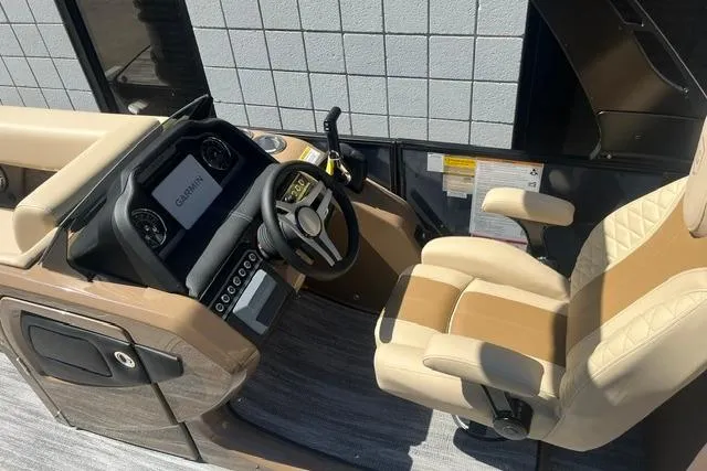 Slide: The Image of Captain's seat and helm of 2026 Godfrey Monaco 235 SB boat, featuring modern controls. - 13
