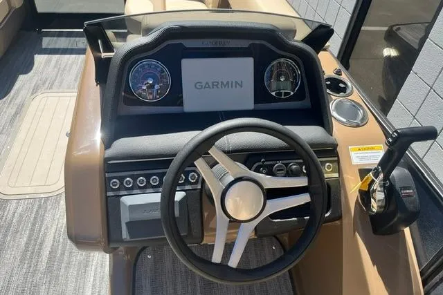 Slide: The Image of 2026 Godfrey Monaco 235 SB boat dashboard with Garmin navigation system and steering wheel. - 14