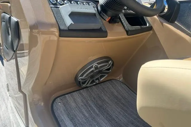 Slide: The Image of 2026 Godfrey Monaco 235 SB boat dashboard with speaker and controls. - 16