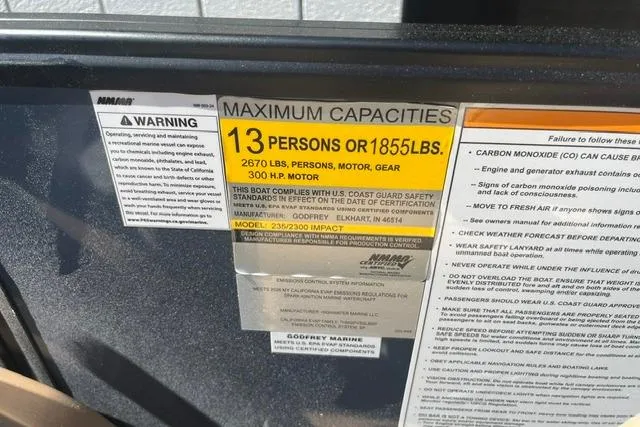 Slide: The Image of Maximum capacity label on 2026 Godfrey Monaco 235 SB boat, 13 persons or 1855 lbs. - 17