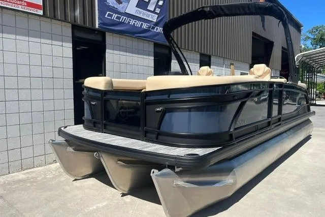Slide: The Image of 2026 Godfrey Monaco 235 SB pontoon boat displayed outdoors at a dealership. - 2
