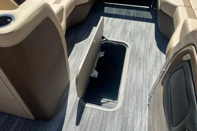 Slide: The Image of 2026 Godfrey Monaco 235 SB interior with open storage compartment on carpeted floor. - 20