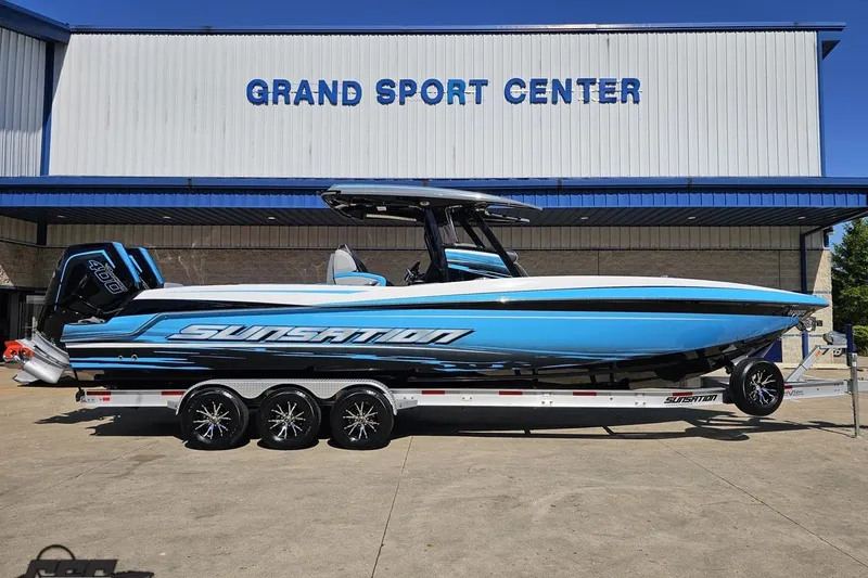 The Image of 2025 Sunsation 32 CCX boat in blue, parked at Grand Sport Center. - 1