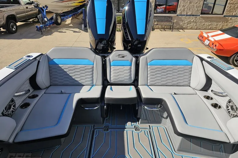 Slide: The Image of 2025 Sunsation 32 CCX boat interior with gray and blue seating, dual engines, and modern design. - 108
