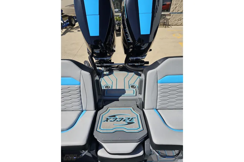 Slide: The Image of 2025 Sunsation 32 CCX boat interior with blue and gray seating and dual outboard motors. - 111