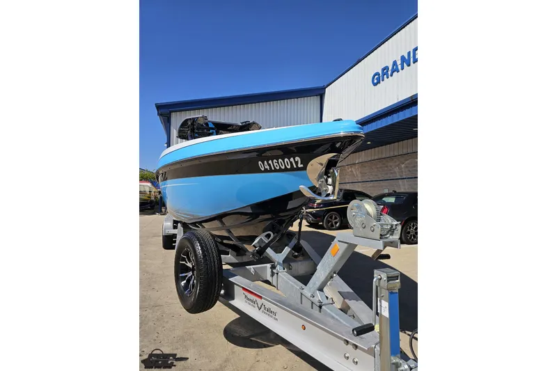 Slide: The Image of 2025 Sunsation 32 CCX boat on trailer, displayed outdoors near a building. - 17