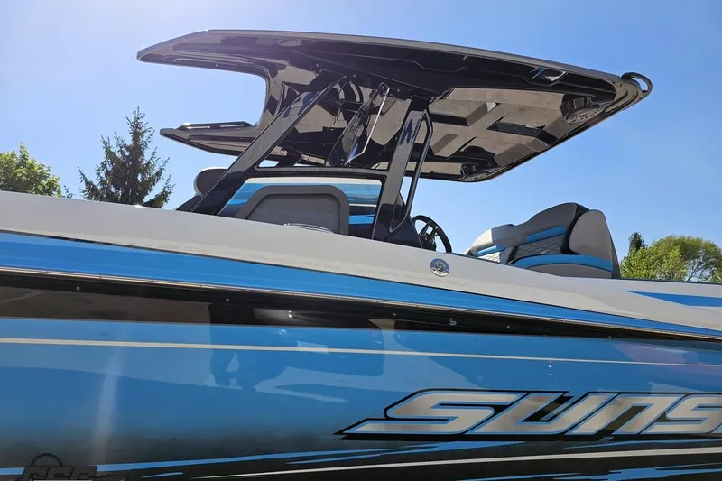 Slide: The Image of 2025 Sunsation 32 CCX boat with sleek blue design and modern features. - 26