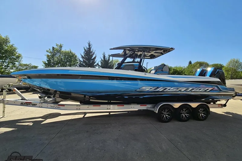 Slide: The Image of 2025 Sunsation 32 CCX boat on trailer, sleek design, vibrant blue color. - 27