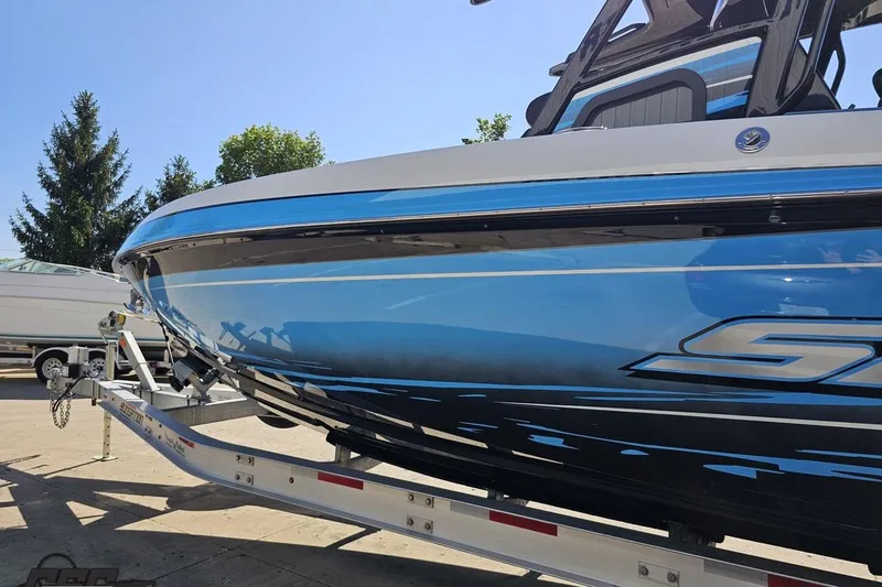Slide: The Image of 2025 Sunsation 32 CCX boat on trailer, featuring sleek blue and black design. - 28