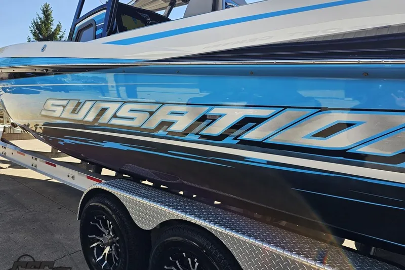 Slide: The Image of 2025 Sunsation 32 CCX boat on trailer, showcasing sleek blue design and branding. - 29