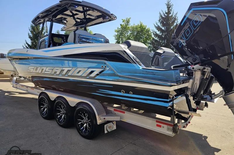 Slide: The Image of 2025 Sunsation 32 CCX boat on trailer, featuring sleek design and powerful engine. - 33